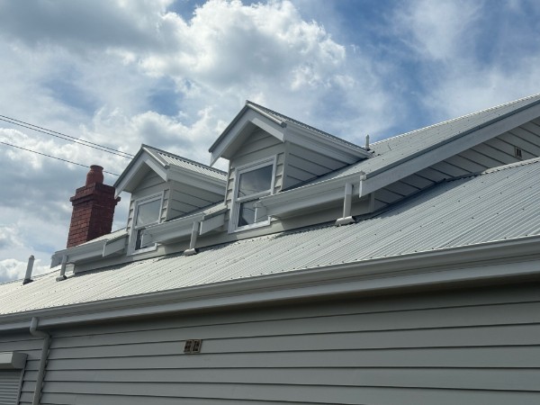 Traditional roof with two dormers showing dormer conversion and custom roof framing work